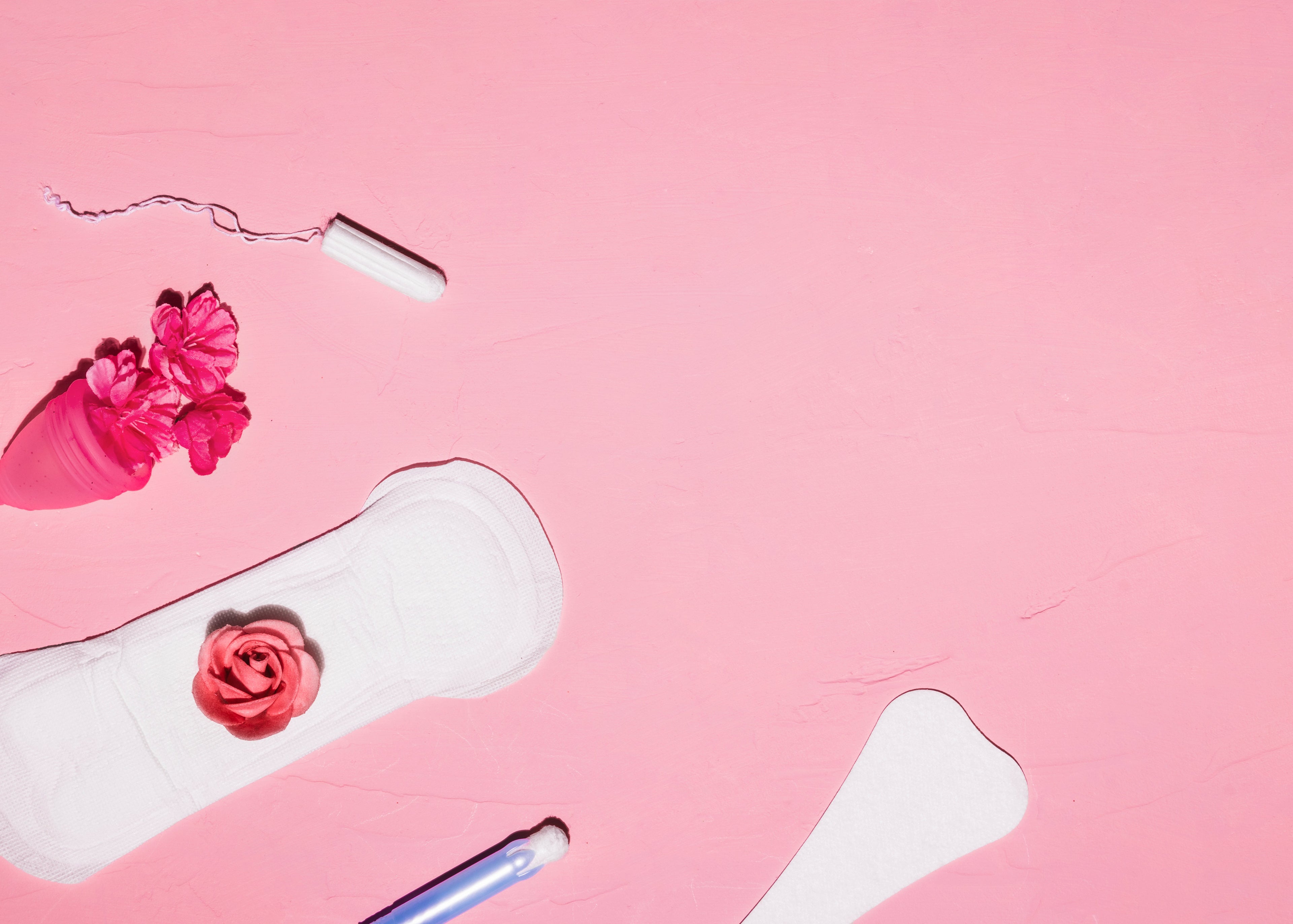 Feminine products alongside flowers